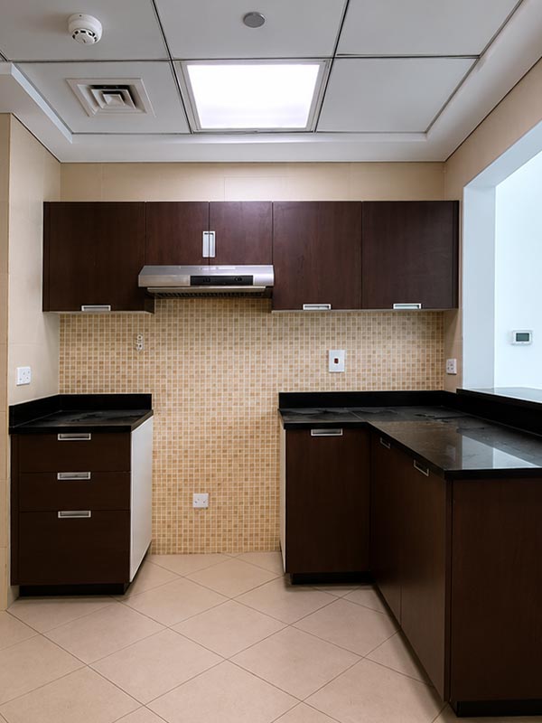 Dark wood kitchen before kitchen wrapping transformation in Dubai Marina
