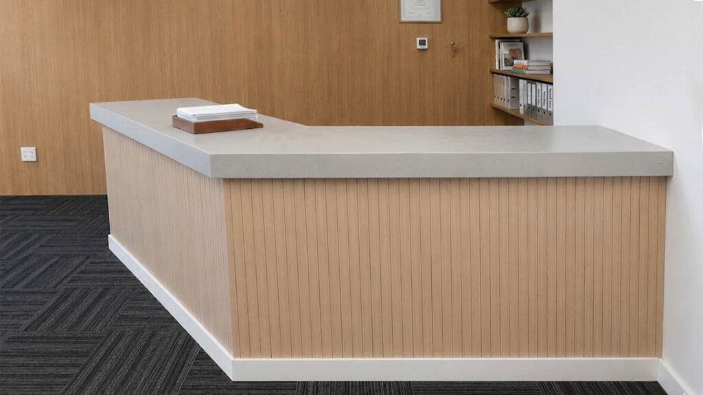 Modern reception counter after vinyl wrapping transformation in Downtown Dubai office