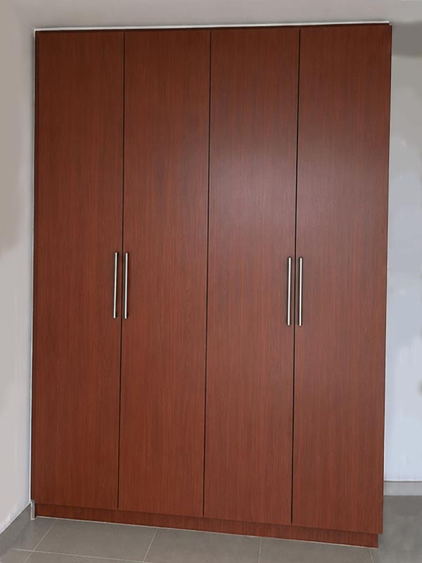 Dark wood wardrobe before wrapping transformation in Dubai apartment