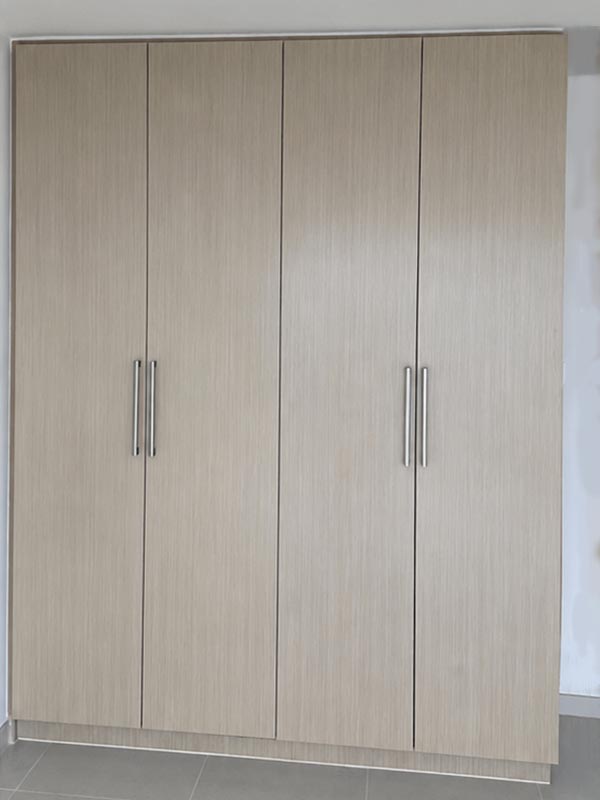 Light wood wardrobe after vinyl wrapping transformation in Dubai apartment