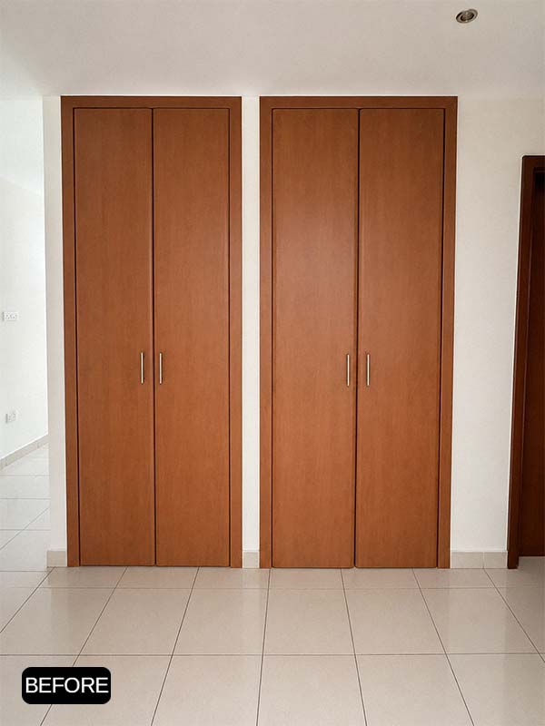 Before wardrobe wrapping in Al Warqa, Dubai, showing the original brown wood built-in wardrobe before applying white matte interior film.