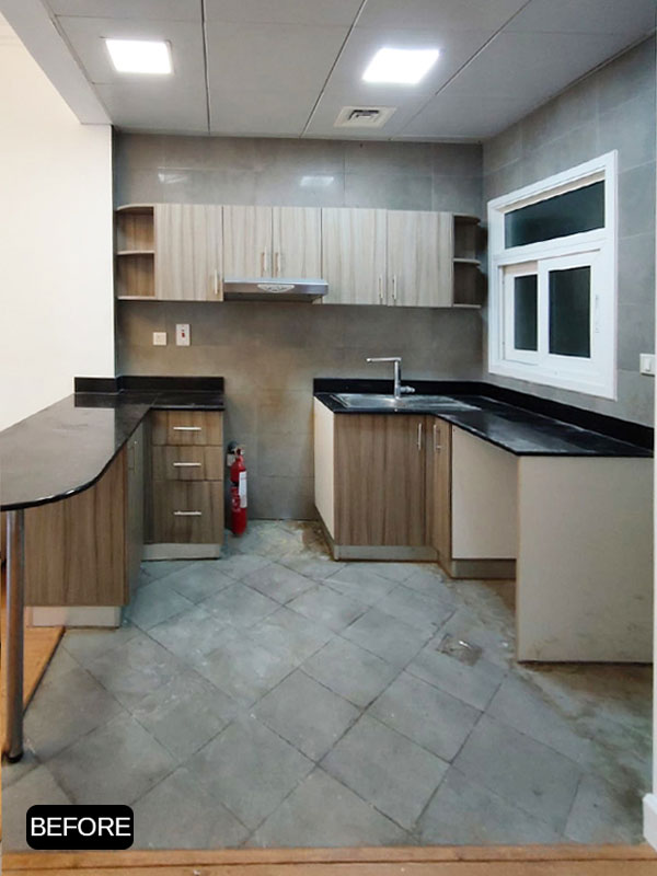 Kitchen before cabinet wrapping at Ayat Oasis, Dubai, featuring original wood grain kitchen cabinets.